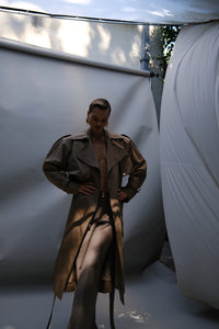 Beige neutral green trench coat crafted from a cotton-blend fabric with contrasting cupro detailing and refined hardware. Finished with classic button fastening, this timeless trench is designed for elevated everyday dressing, city styling and transitional cold-weather layering.