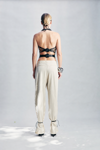 Black leather effect macrame top, fully handmade and meticulously crafted over 20 hours. Featuring a sculptural silhouette and distinctive leather-covered buckle detailing, this statement top is designed for bold eveningwear, special occasions, parties and elevated winter dressing.