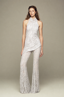 Fully hand-embroidered tulle top in white with all-over sequins and flared legs for a sleek, sparkling look. Designed for your holiday wardrobe and special special events.
