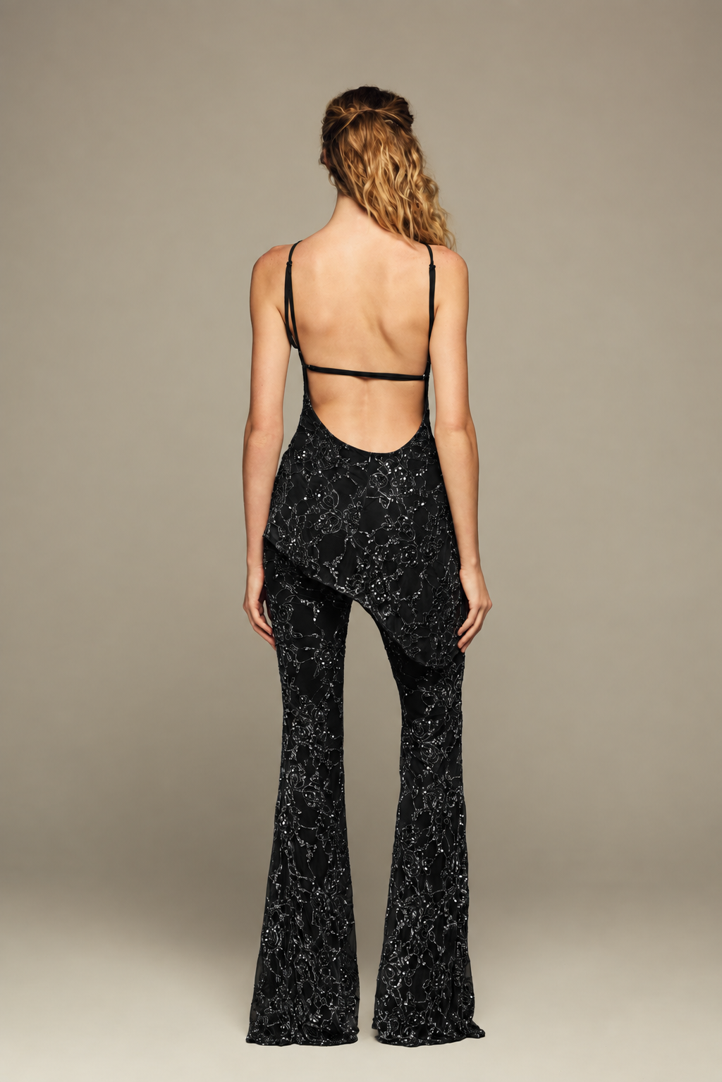 Fully hand-embroidered tulle set in black with all-over sequins and flared legs for a sleek, sparkling look. Designed for your holiday wardrobe and special special events.