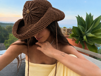 Hand-crocheted chocolate brown cotton sun hat with beaded sunburst embroidery and an oversized brim, the perfect luxury accessory for summer holidays and beach vacations.