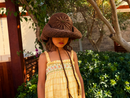 Hand-crocheted chocolate brown cotton sun hat with beaded sunburst embroidery and an oversized brim, the perfect luxury accessory for summer holidays and beach vacations.