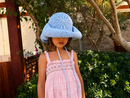 Hand-crocheted baby blue cotton sun hat with beaded sunburst embroidery and an oversized brim, the perfect luxury accessory for summer holidays and beach vacations.
