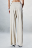 Beige cotton-gabardine trousers featuring a structured tailored silhouette and contrasting button accents along the legs. Finished with classic zip and button fastening. Designed for refined everyday dressing, modern tailoring, workwear and sophisticated winter looks.