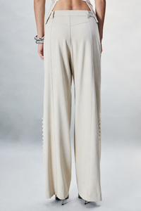 Beige cotton-gabardine trousers featuring a structured tailored silhouette and contrasting button accents along the legs. Finished with classic zip and button fastening. Designed for refined everyday dressing, modern tailoring, workwear and sophisticated winter looks.
