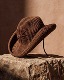 Hand-crocheted chocolate brown cotton sun hat with beaded sunburst embroidery and an oversized brim, the perfect luxury accessory for summer holidays and beach vacations.